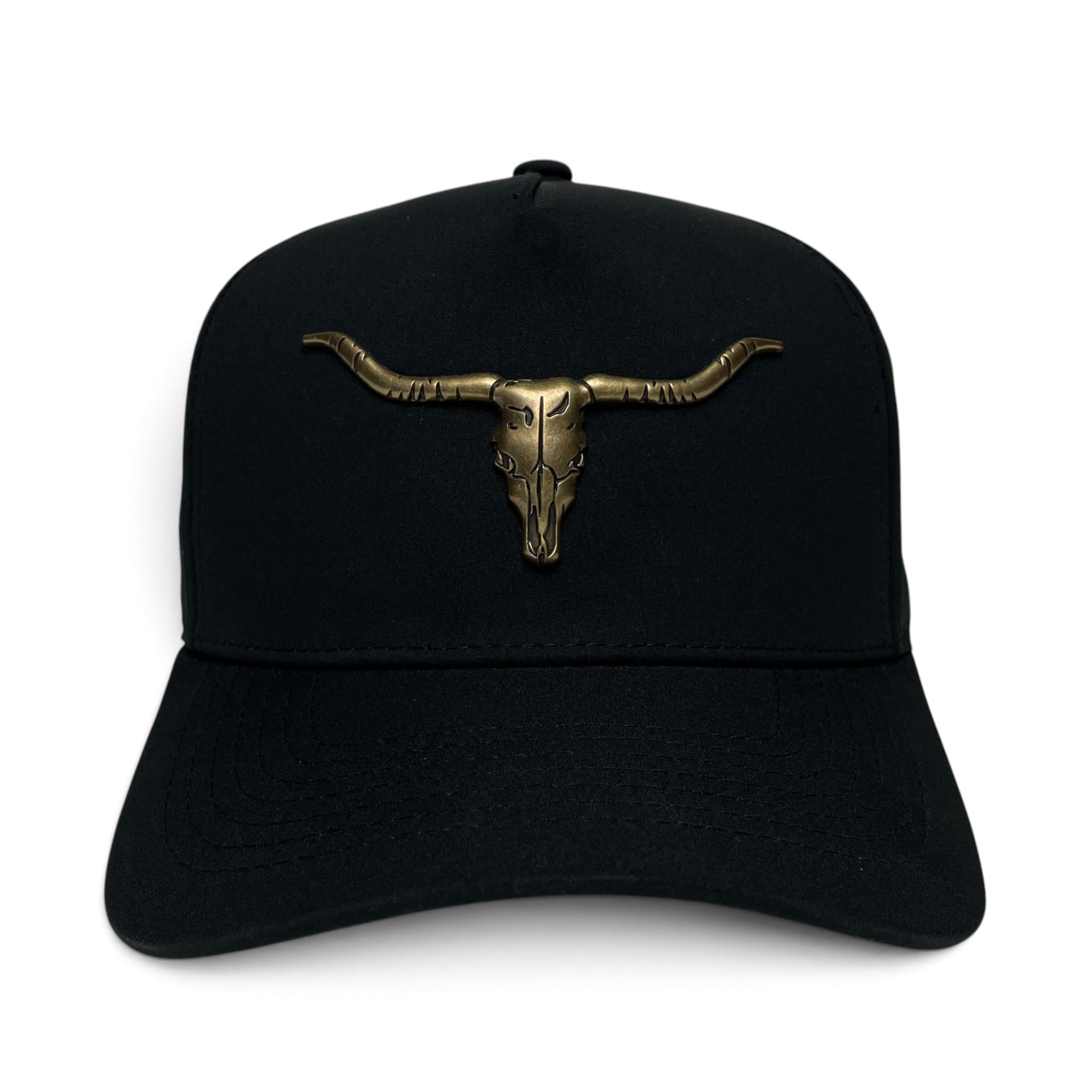 A black baseball cap featuring a metallic bronze bull skull with long curved horns on the front, set against a plain white background.