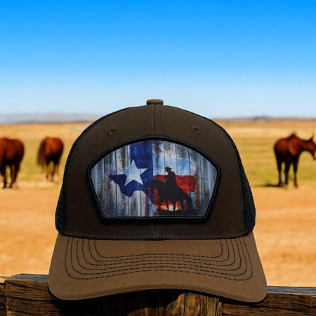 Brown snapback trucker hat with cowboy riding a horse and Texas flag patch