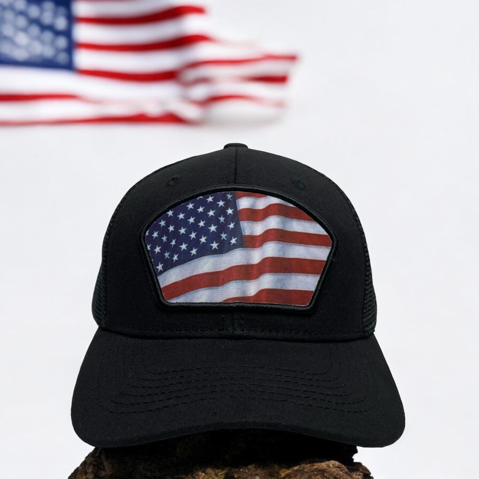 Black trucker hat with printed USA flag patch - front view